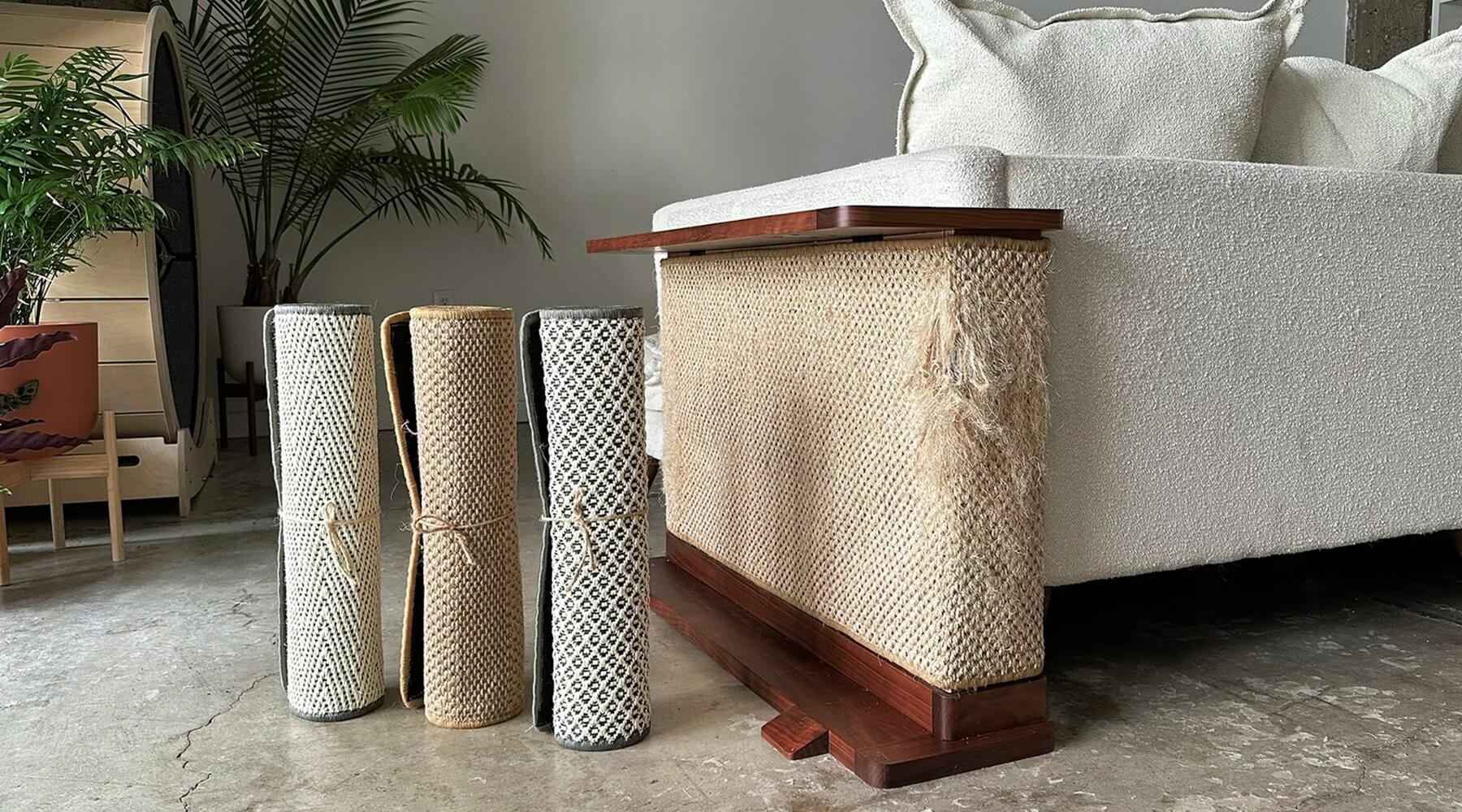 Three rolled-up Hilde & Phil sisal mats for cats stand next to a worn cat scratcher, illustrating the need to replace cat scratchers