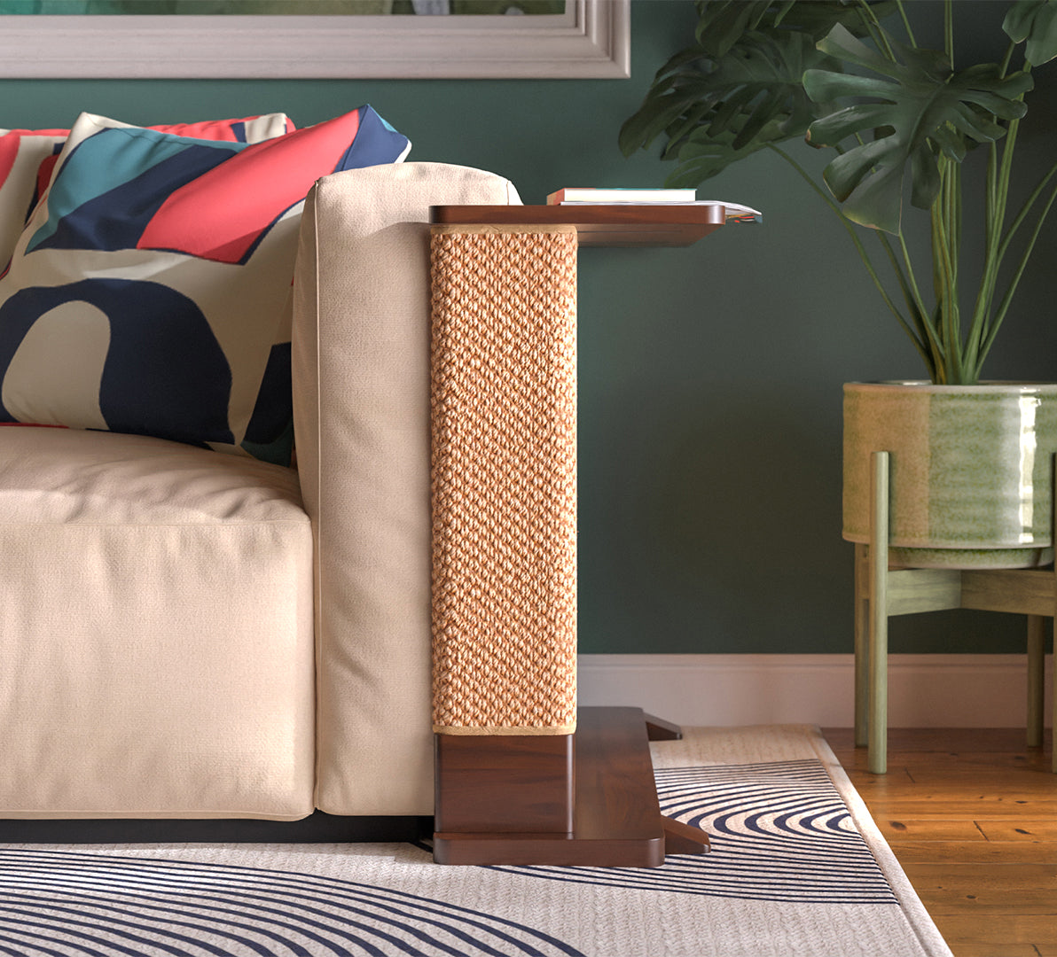 A Cat-e-Corner table placed next to a sofa, integrating a cat's scratching post with a small table, in a room with a plant and a colorful cushion.