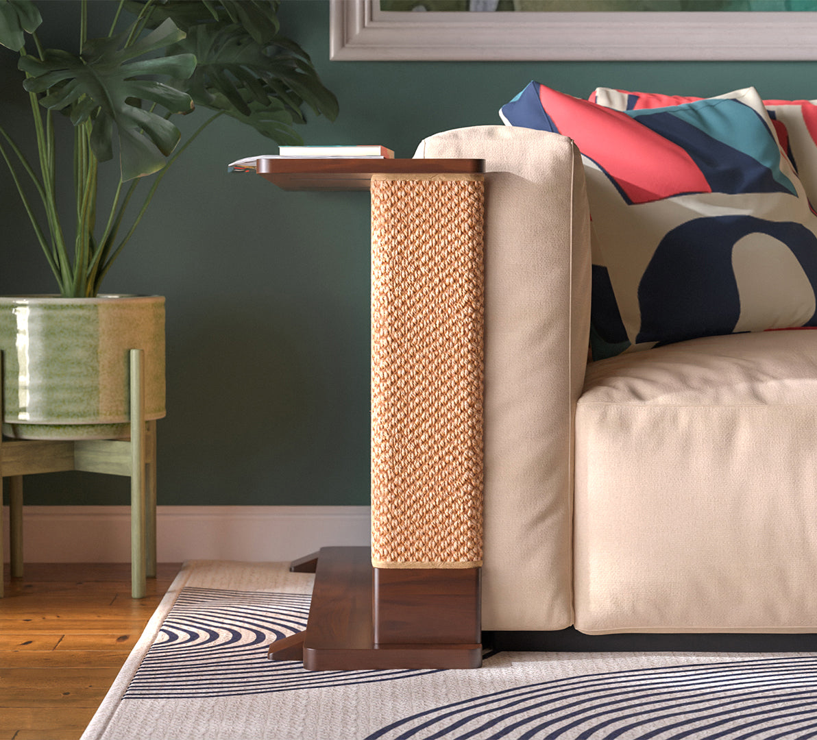 A Cat-e-Corner table placed next to a sofa, integrating a cat's scratching post with a small table, in a room with a plant and a colorful cushion.
