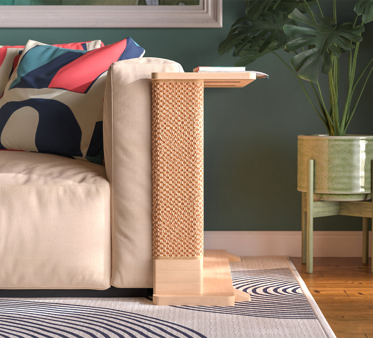 A Cat-e-Corner table placed next to a sofa, integrating a cat's scratching post with a small table, in a room with a plant and a colorful cushion.