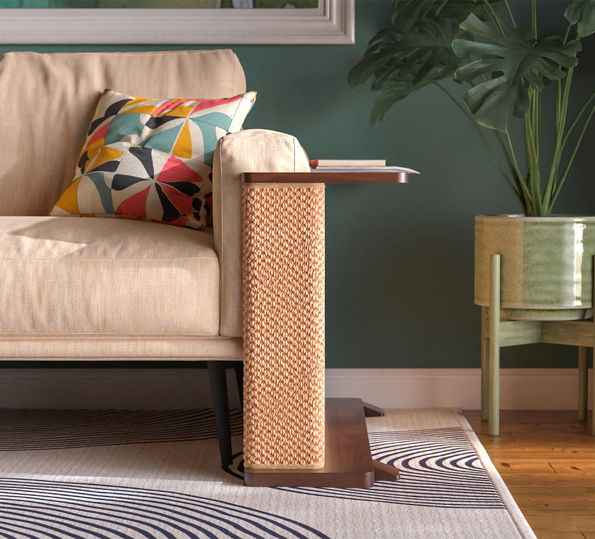 A Cat-e-Corner table placed next to a sofa, integrating a cat's scratching post with a small table, in a room with a plant and a colorful cushion.